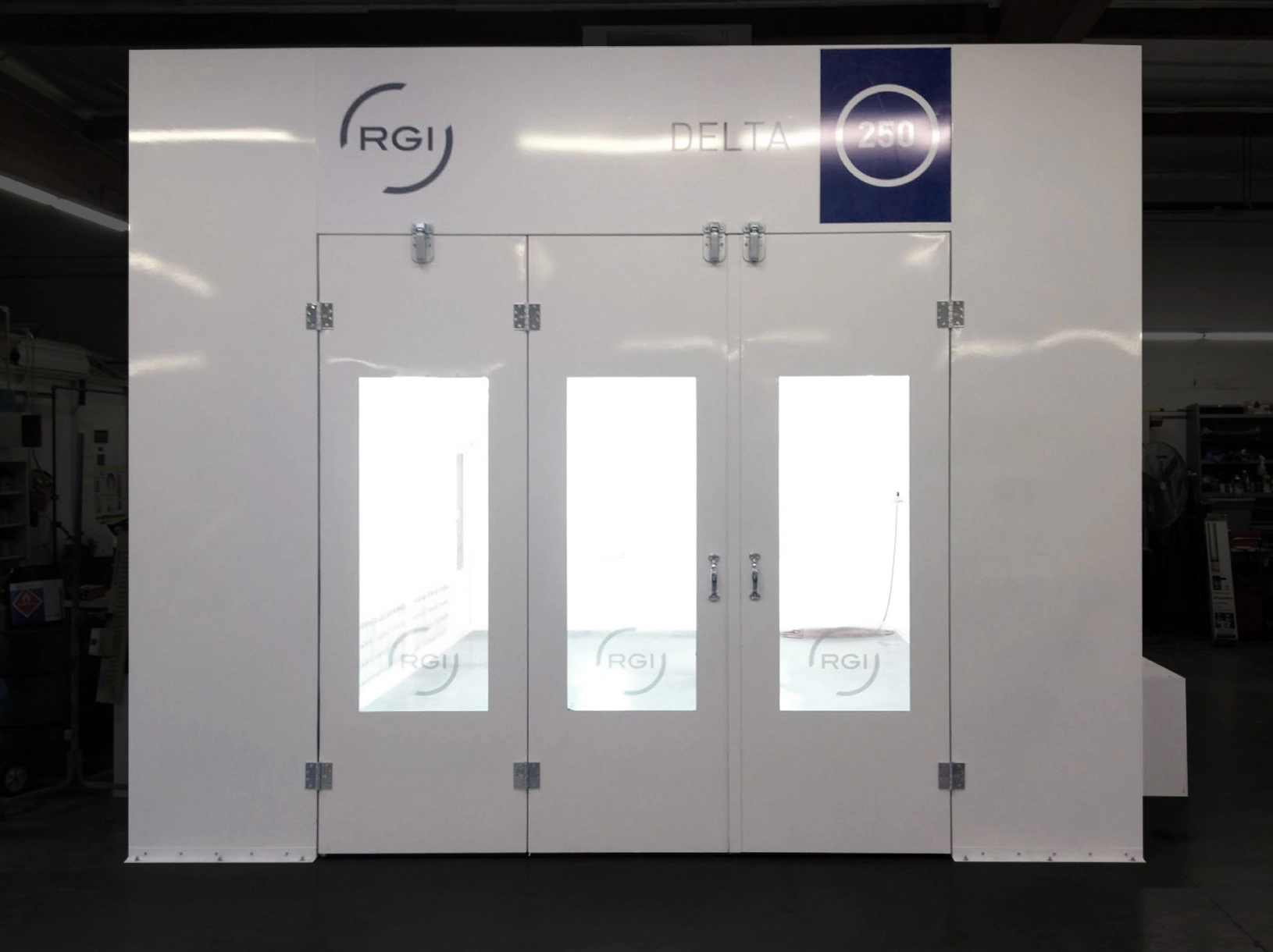 A large white industrial booth with three doors, each featuring a window, and logos of rgi and delta 260 at the top.